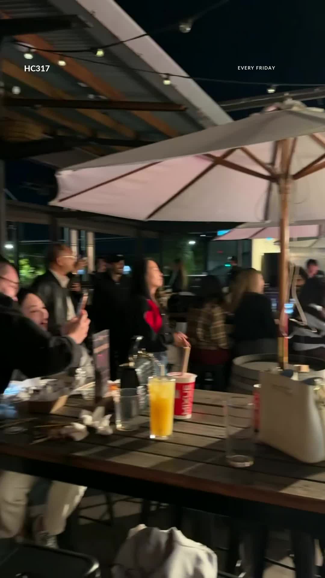 Footage of a past Friday gathering on the rooftop with guests and live music. Visit our Instagram for current event dates.